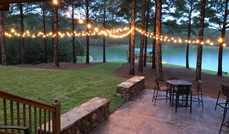 Lakeside patio under string lights at Hurricane Creek